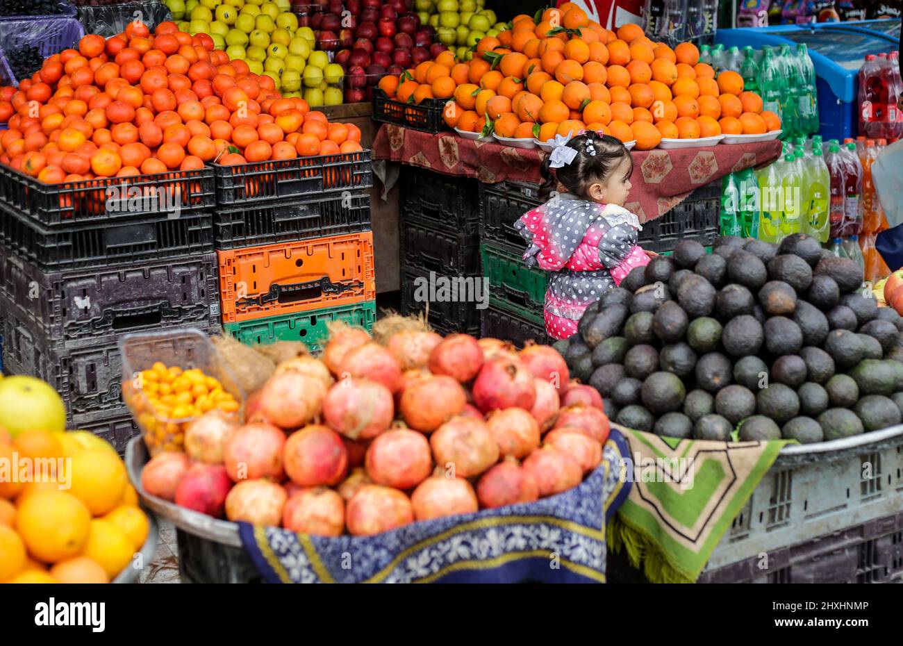 A Palestinian girl standing at a grocery store in the northern Gaza