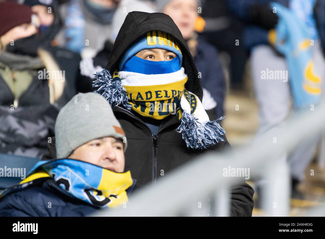 American soccer fans dressed for the cold at a football match after a