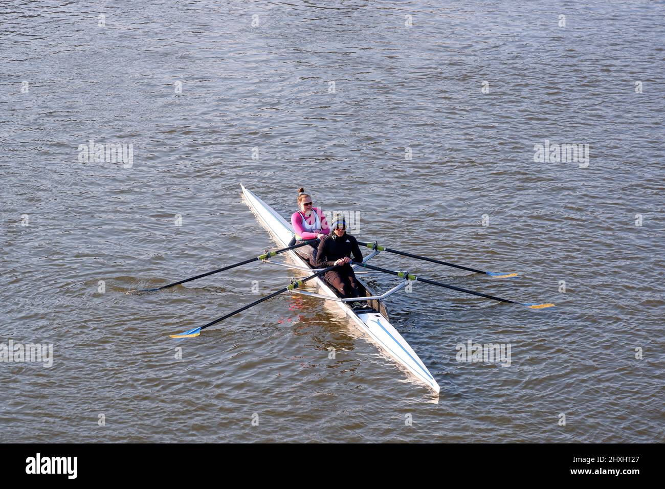 Two people in a fast row boat Stock Photo