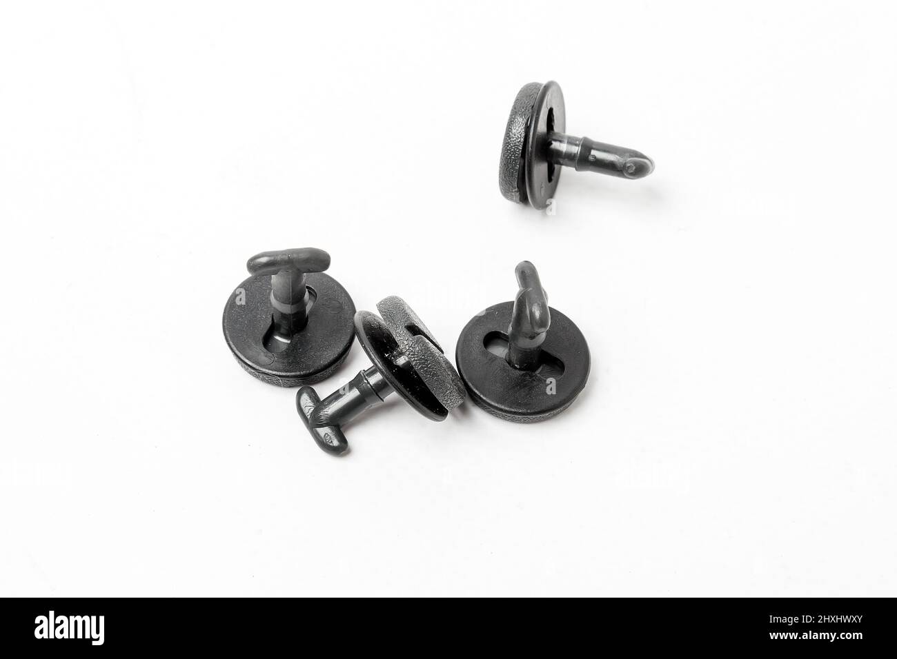 Macro shot plastic black clips for the car. Panel plastic rivets Isolated  on a white background. Automotive clips . Auto plastic fasteners. Clip or  au Stock Photo - Alamy