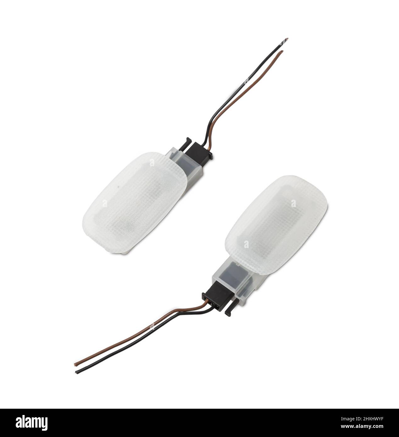 A pair of transparent plastic shades for illuminating the interior on a white isolated background in a photo studio - spare parts for repairing a car Stock Photo