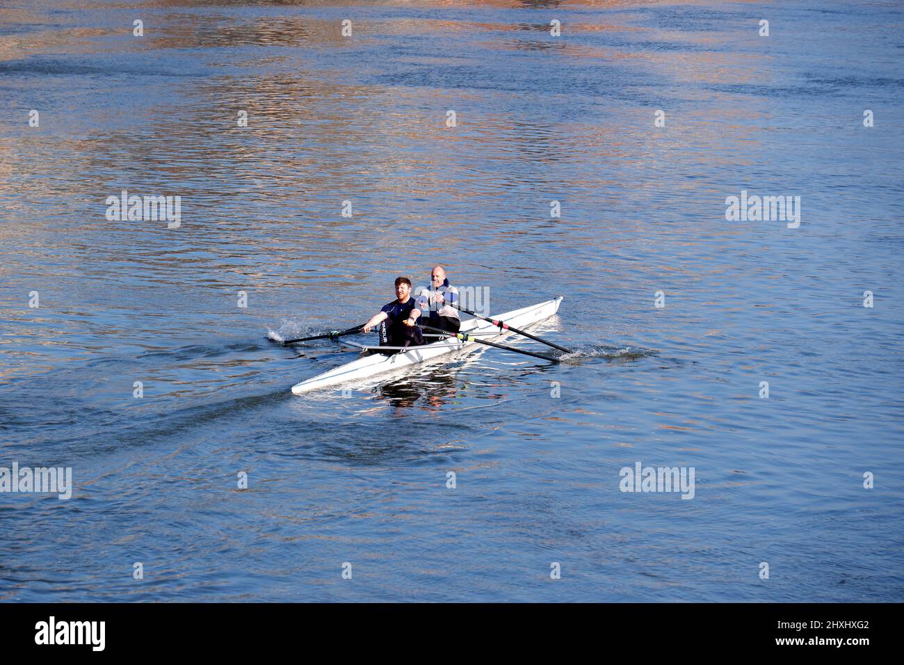 Two people in a fast row boat Stock Photo