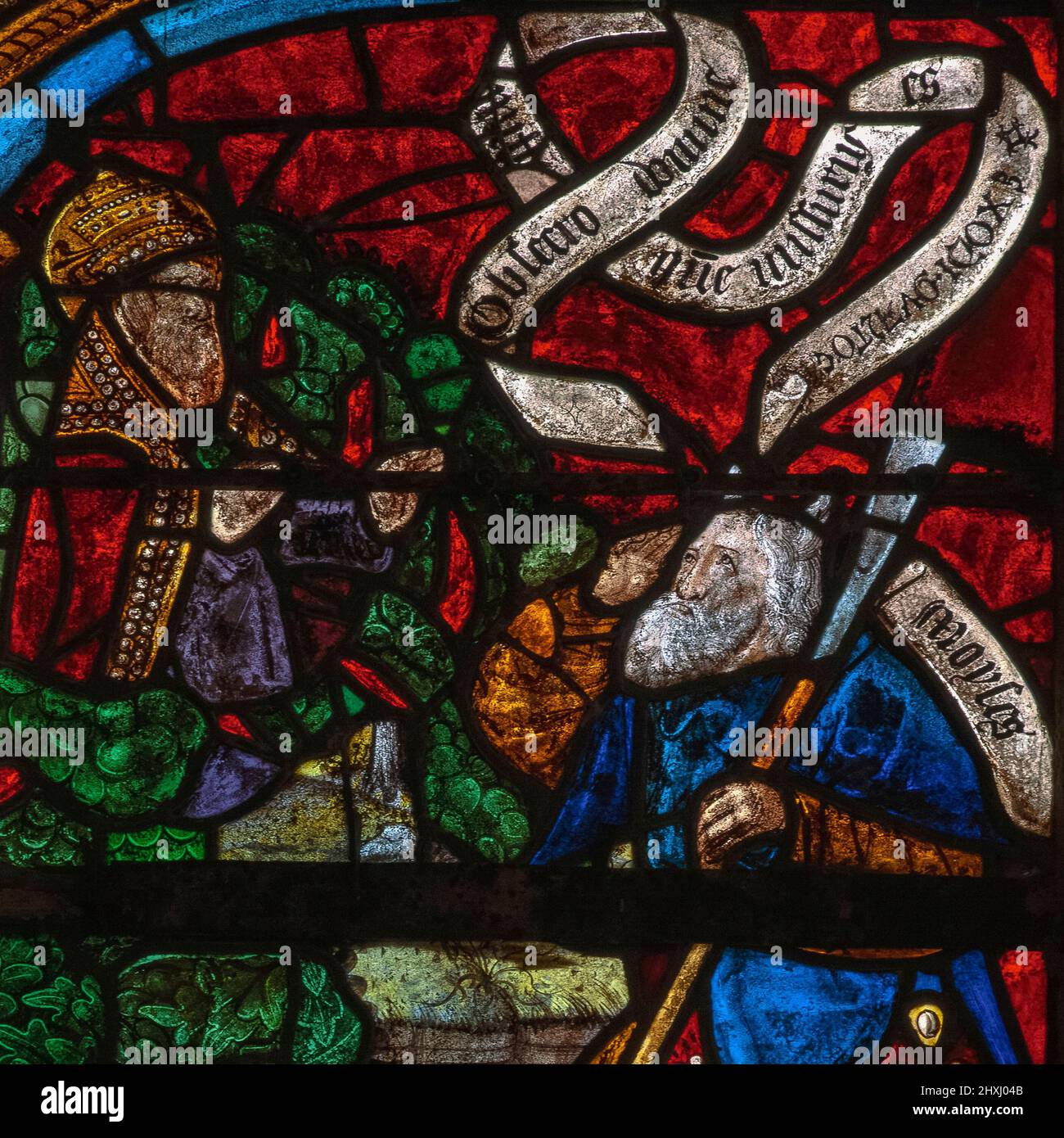 The prophet Moses listens as God, appearing in the Burning Bush, instructs him to lead the Israelites out of Egypt and into Canaan, the land of 'milk and honey': square detail of Tree of Jesse window, by the stained glass masters of Troyes, installed in 1512 in the Église Saint-Rémi, the parish church at Ceffonds, Haute-Marne, Grand Est, France. Stock Photo