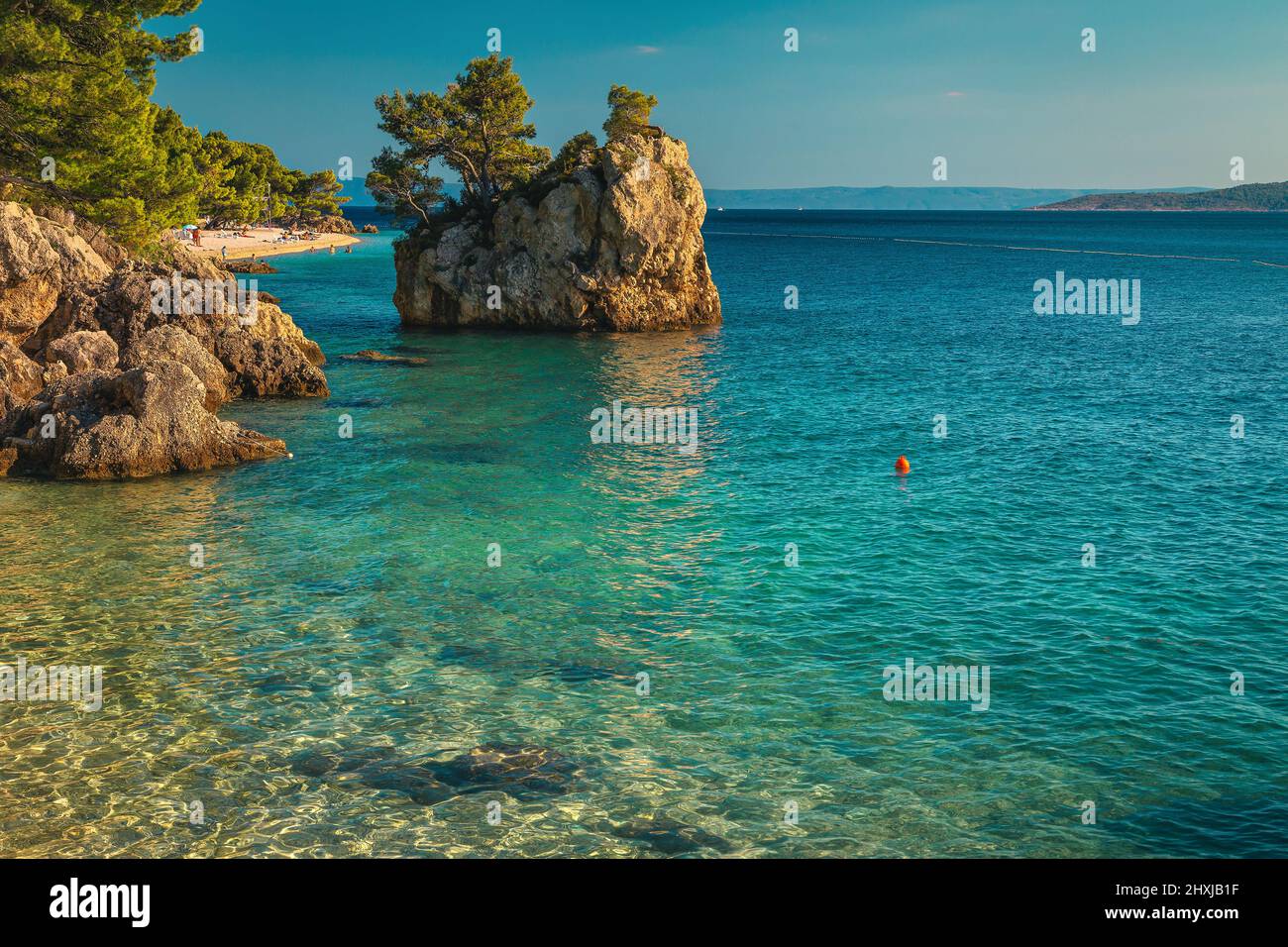 Stunning landscape with clean sea and majestic rock island on the beach. One of the best visited beach in Dalmatia, Brela, Makarska riviera, Croatia, Stock Photo