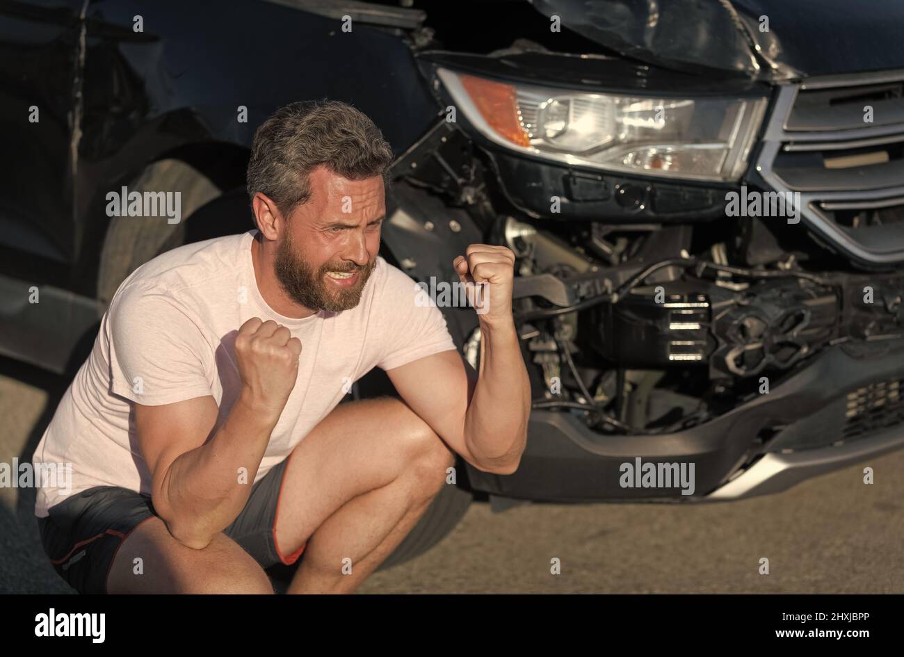 frustrated man driver at broken car after automobile collision car accident, car insurance Stock Photo