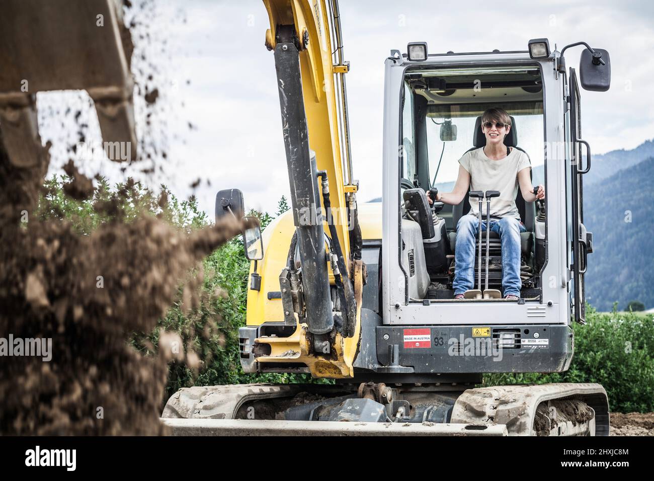 female excavator driver at work Stock Photo