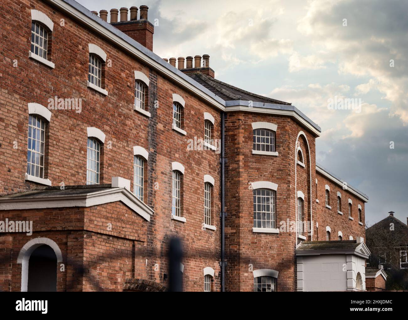 Old abandoned Victorian workhouse for paupers with dramatic sky above Stock Photo