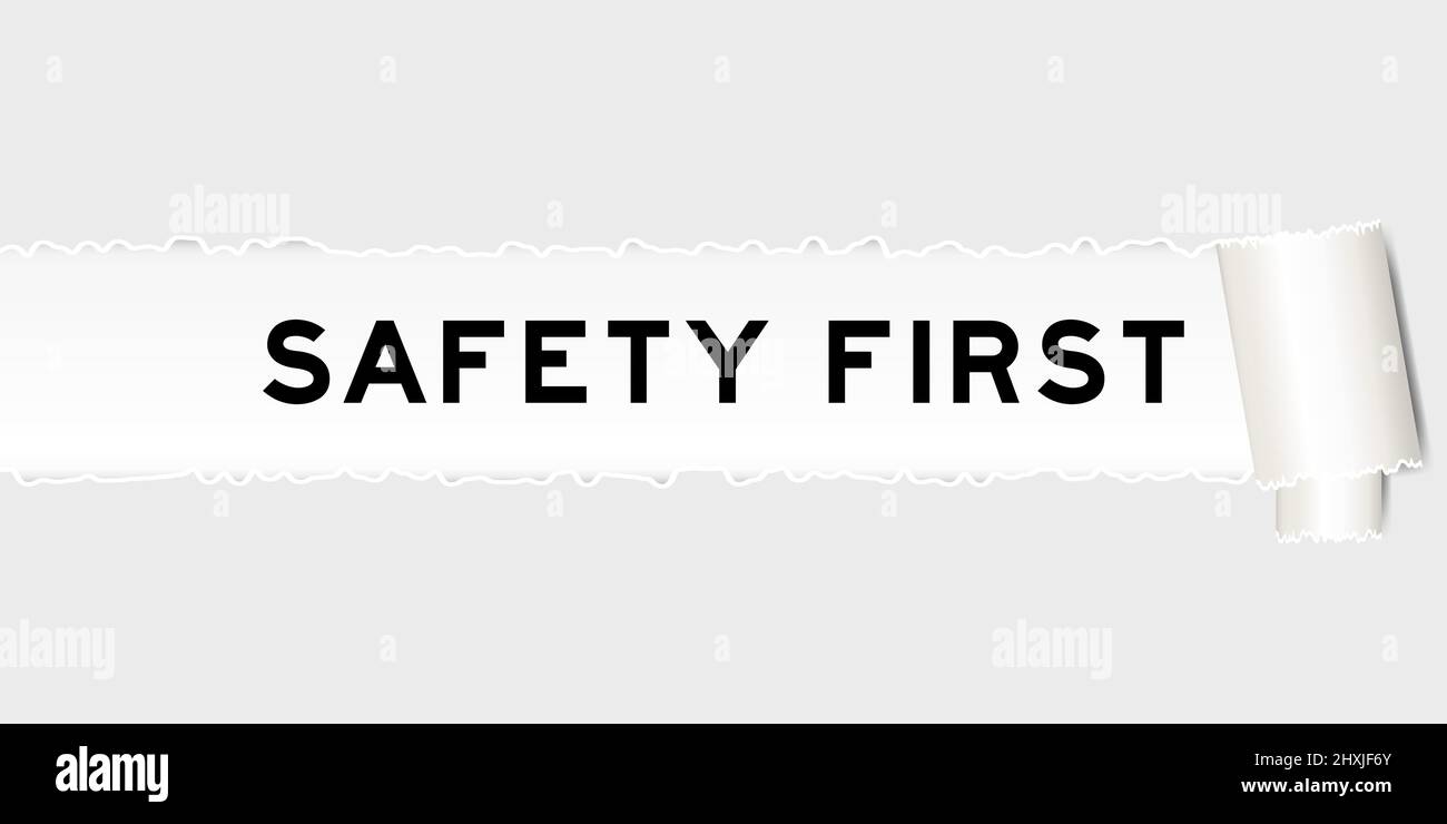 Ripped gray paper background that have word safety first under torn ...