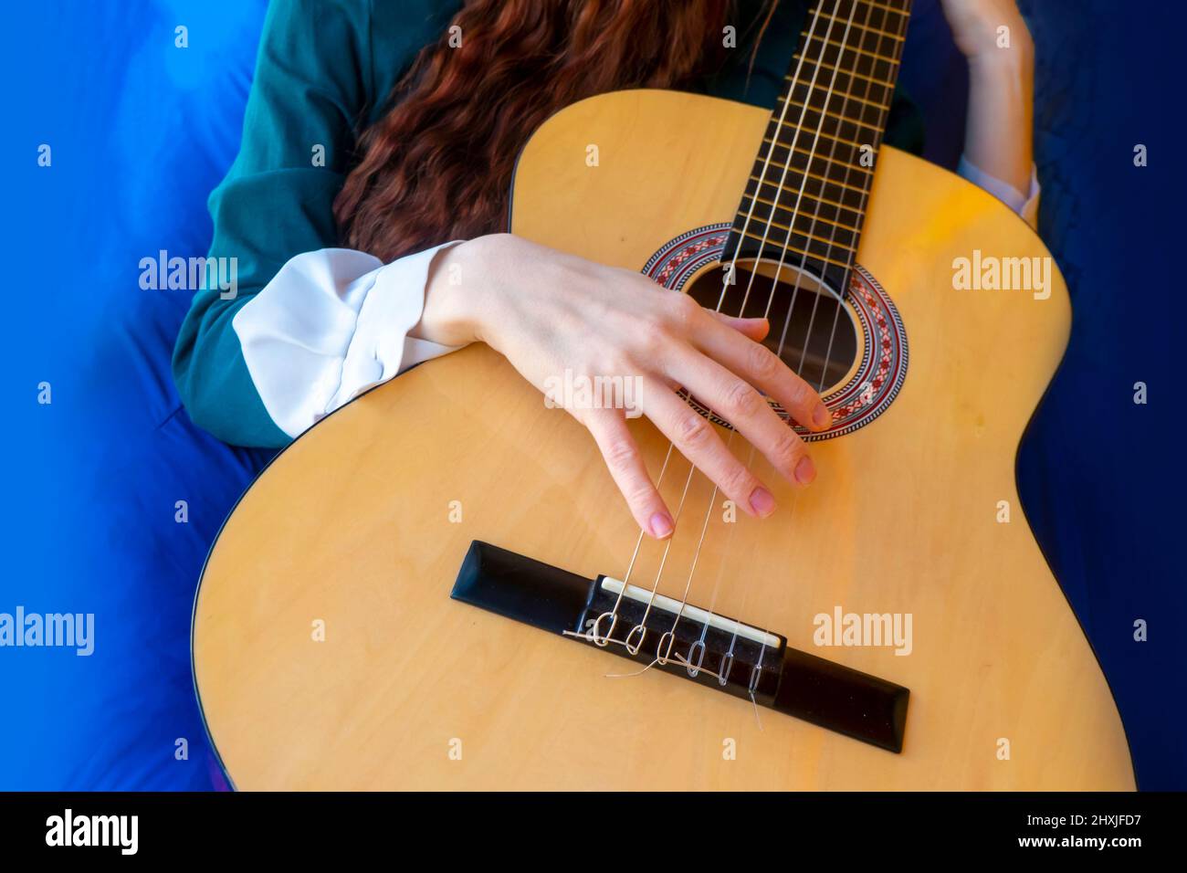 Close-up of female hands playing classical guitar Stock Photo