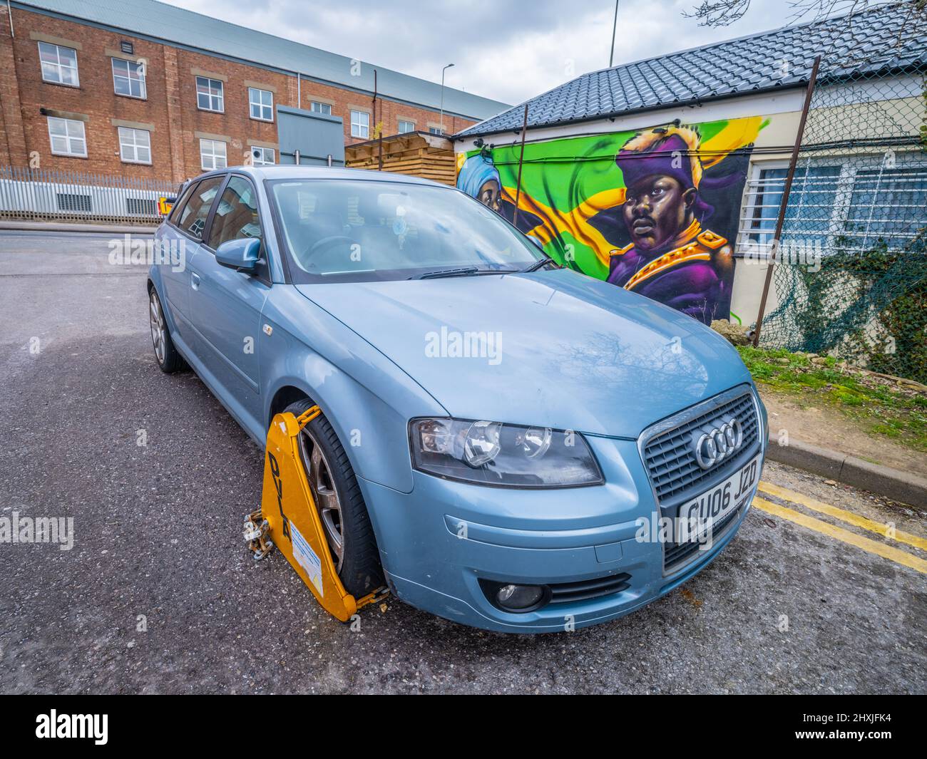A car is clamped due to having no road tax. Stock Photo
