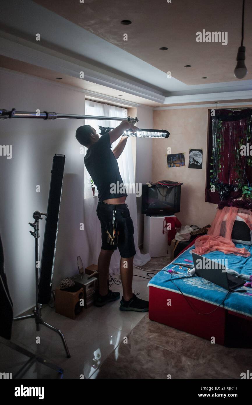 Behind the scene. Filmmaking lighting technician electric engineer