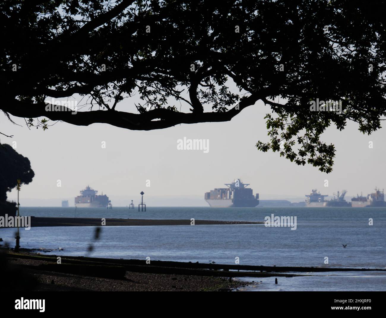 Oil tankers and container ships come and go at the entrance to Southampton Water and the Solent. Stock Photo