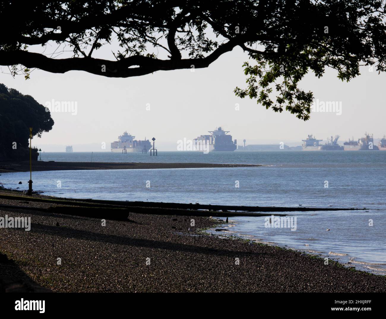 Oil tankers and container ships come and go at the entrance to Southampton Water and the Solent. Seen from Netley. Stock Photo
