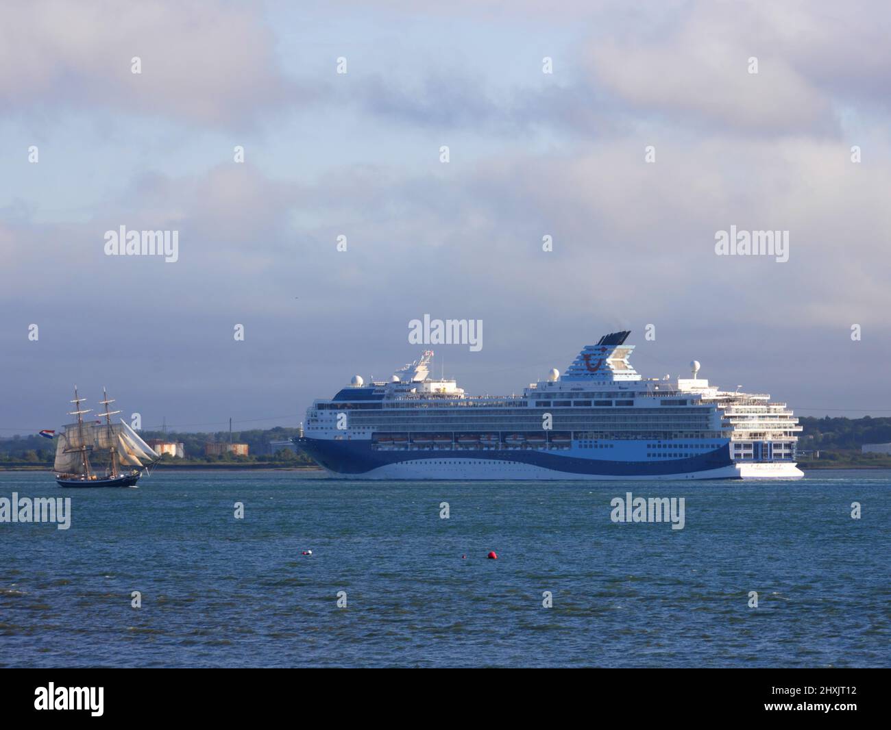 TUI cruise ship Marella Explorer passes SV Tenacious as she leaves Southampton, Hampshire. Stock Photo
