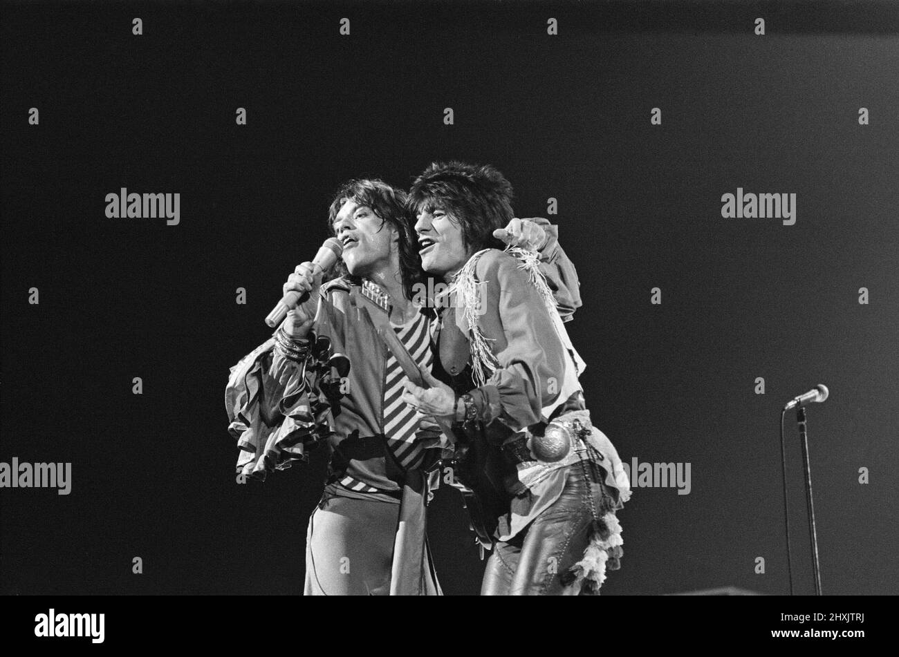 The Rolling Stones - live at Earl's Court, West London. Picture shows Mick Jagger and Ronnie Wood together onstage.  This concert was part of the 1976 European Tour. It started in Frankfurt Germany on 28th April and ended at Knebworth in England on 21st August 1976.  Whilst we cannot confirm the actual set list for this show, a typical set list for this tour was...  'Honky Tonk Women' 'If You Can't Rock Me'/'Get off of My Cloud' 'Hand of Fate' 'Hey Negrita' 'Ain't Too Proud to Beg' 'Fool to Cry' 'Hot Stuff' 'Star Star' 'Angie' - [played some shows] 'You Gotta Move' 'You Can't Always Get What Y Stock Photo
