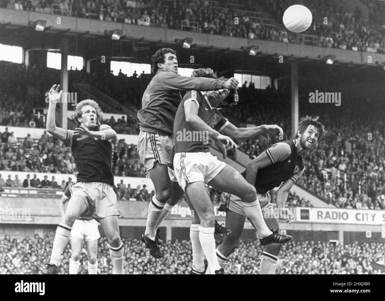 English League Division One match at Goodison Park. Everton 0 v Aston Villa 2. Villa goalkeeper John Burridge punches the ball clear from the challenge of Mick Lyons as Vill players Andy Gray (left) and Chris Nicholl look on. 28th August 1976. Stock Photo