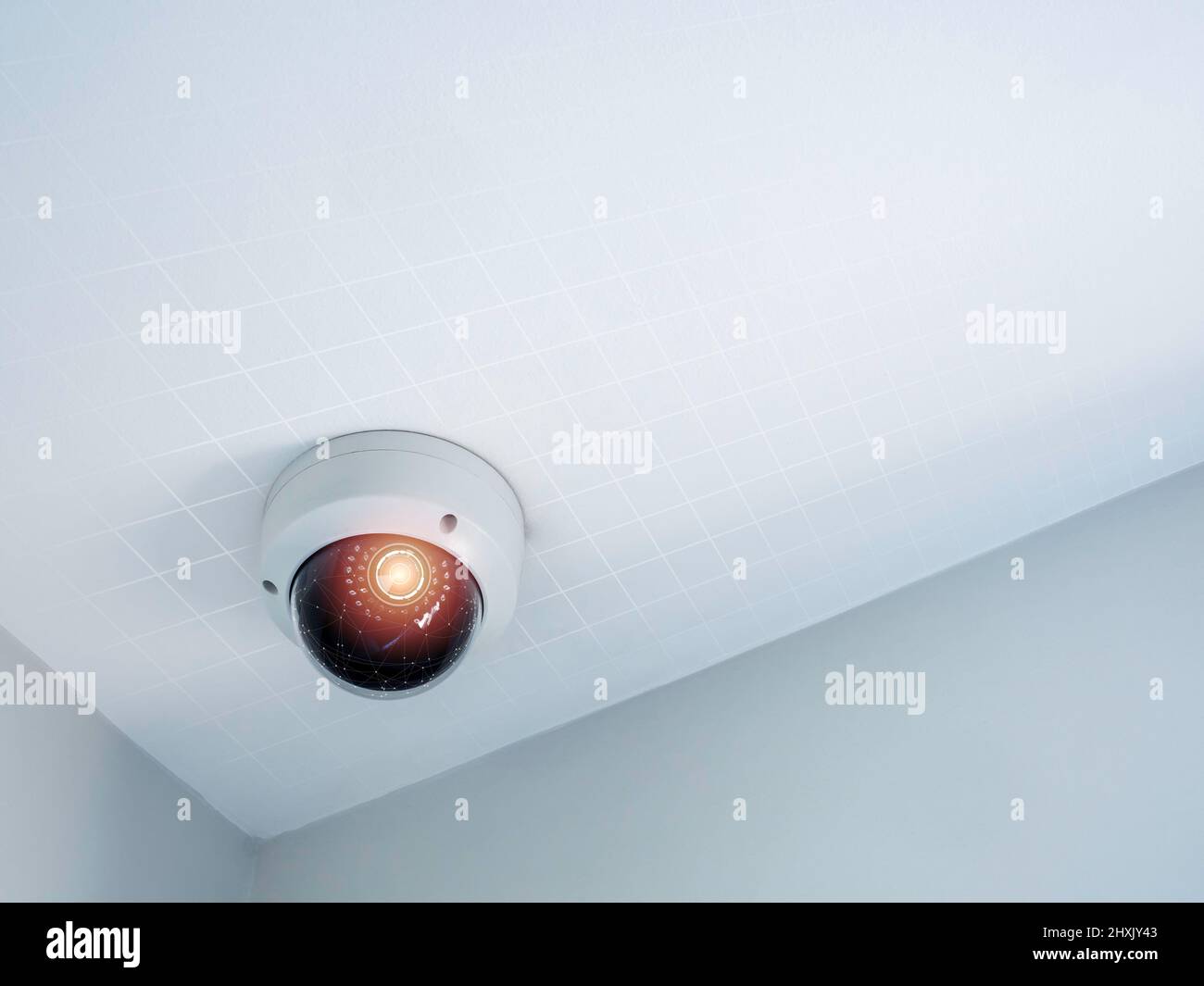 Digital security eye. A white round indoor CCTV surveillance camera monitoring security on