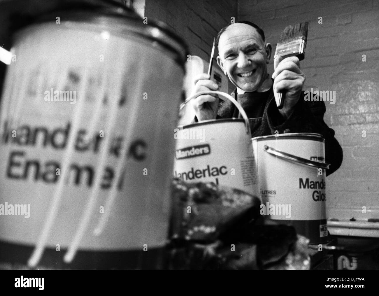 Arthur Woodfield maintenance painter at Round Oak Steelworks, Brierley Hill, West Midlands, is giving up his big paint brush to take up a smaller model, Arthur plans to become an artist in retirement, pictured 11th January 1977. Stock Photo