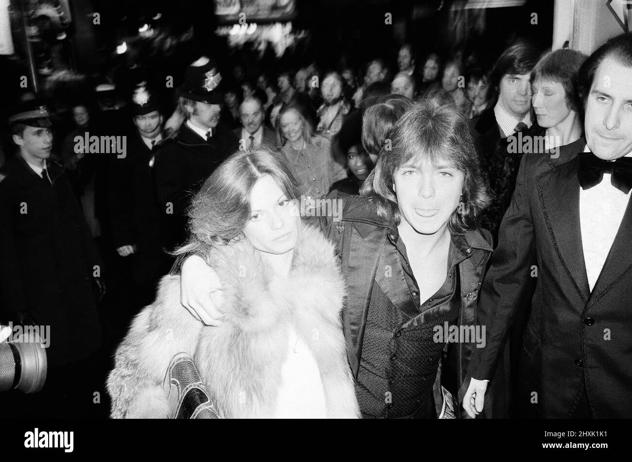 David Cassidy, singer, actor and musician, in London. 1977. David arrives at The Rialto Cinema, Leicester Square, London for the film premiere of The Great Scout and Cathouse Thursday with his secret fianc¿ Kay Lenz  David Bruce Cassidy is widely known for his role as Keith Partridge in the 1970s musical sitcom The Partridge Family, which led to his becoming one of pop culture's most celebrated teen idols and pop singers of the 1970s. He later had a career in both acting and music.  Picture taken 10th March 1977David Cassidy, singer, actor and musician, in London. 1977.  David arrives at The R Stock Photo