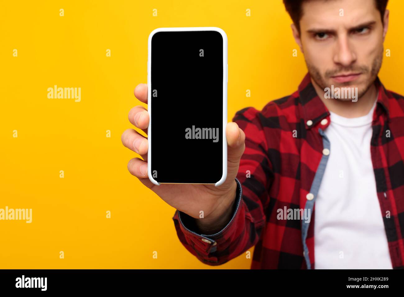 Sad guy holding showing empty smartphone screen Stock Photo