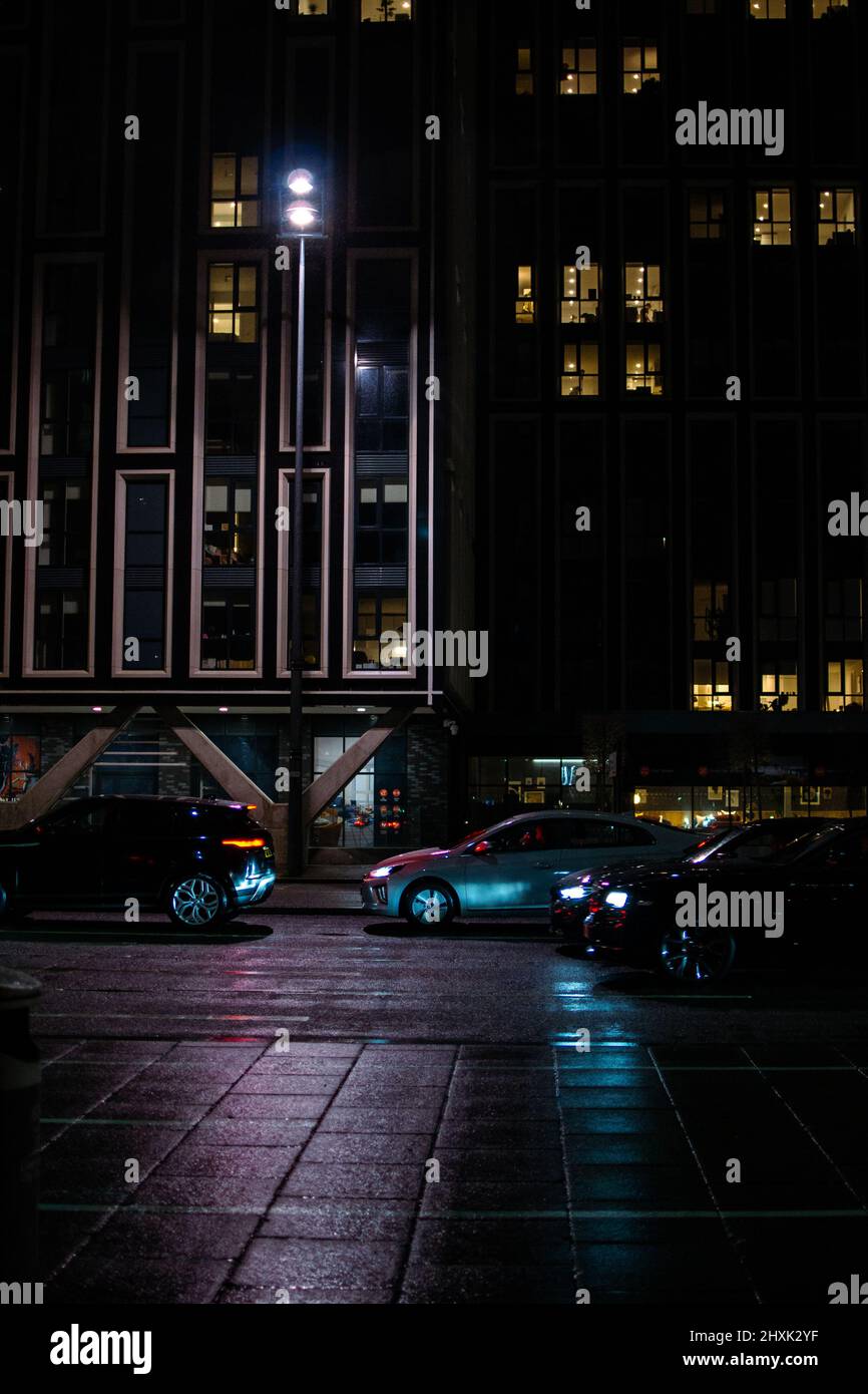 Portrait shot of The Strand, Liverpool, with assorted traffic, overlooked by towering skyscrapers. Stock Photo