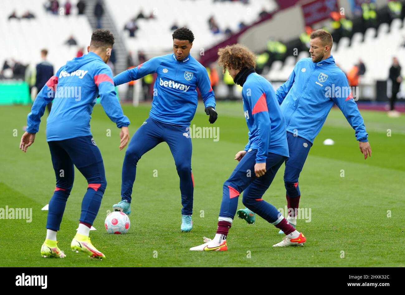 Left to right, West Ham United's Ryan Fredericks, Armstrong Oko-Flex, Alex Kral and Andriy Yarmolenko warming up before the Premier League match at the London Stadium, London. Picture date: Sunday March 13, 2022. Stock Photo