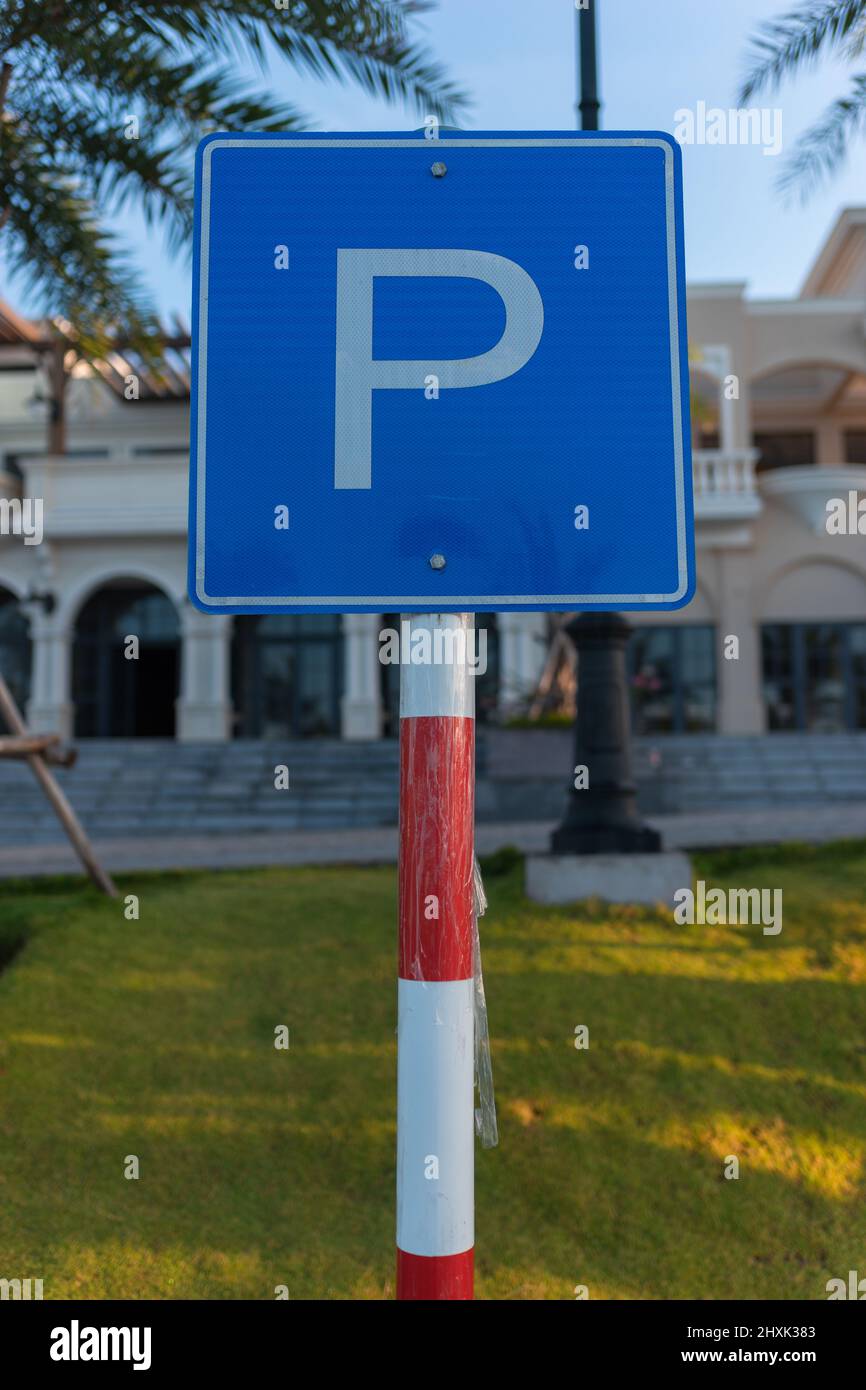 parking sign stands on the street, summer, green grass. Place for the parking in the city. High quality photo Stock Photo