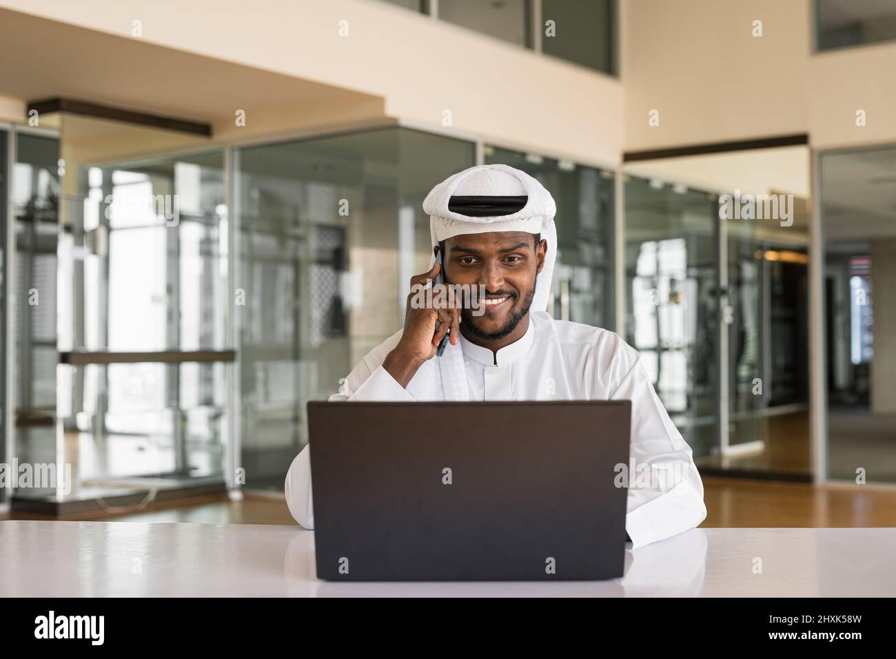 African Muslim man using laptop computer at office Stock Photo