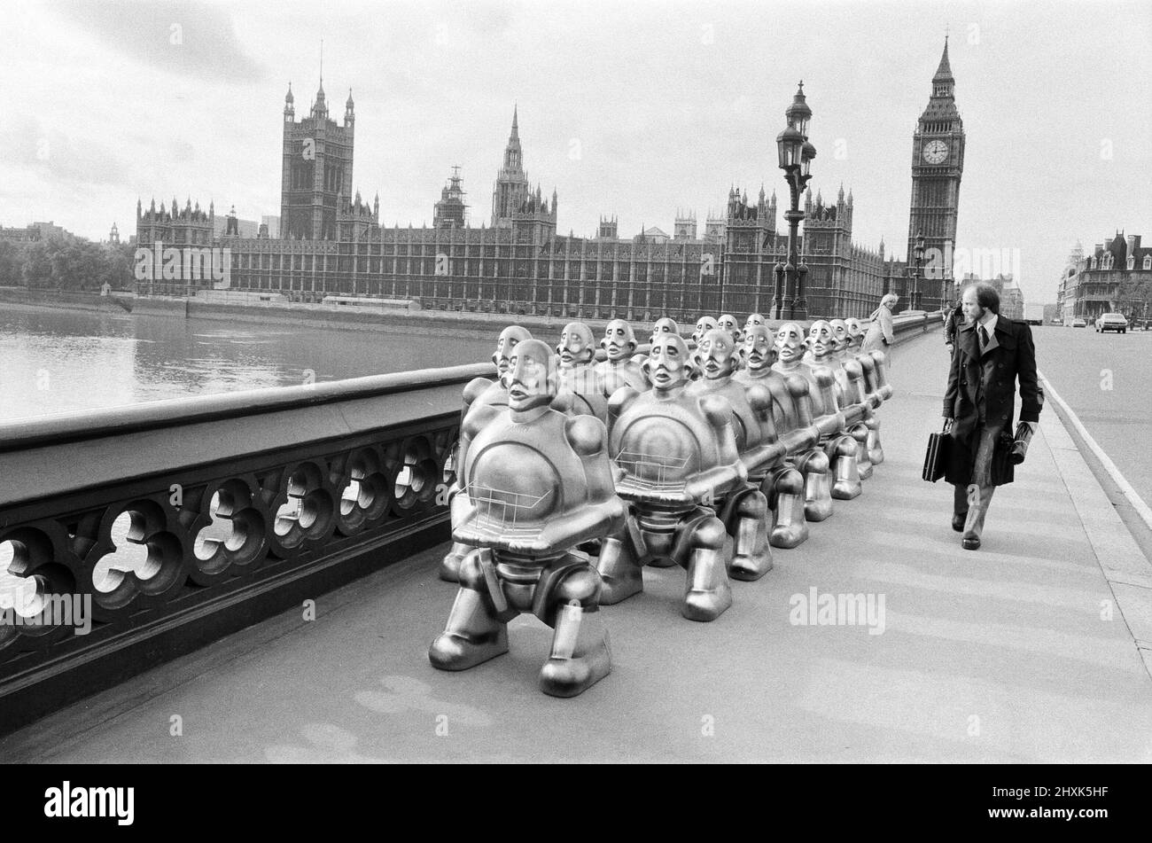 Robots lined up over Westminster Bridge. The robots were supplied by EMI Records who used them on the cover of the latest album by 'Queen'. The invasion of Westminster was halted by a single traffic policeman. 2nd November 1977. Stock Photo