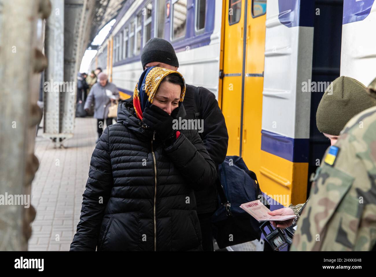 Lviv, Ukraine. 12th Mar, 2022. A woman cries as the Ukrainian soldiers
