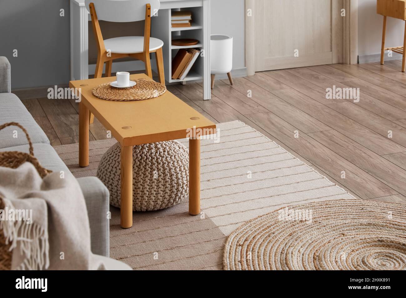 Modern table and sofa in interior of room Stock Photo - Alamy
