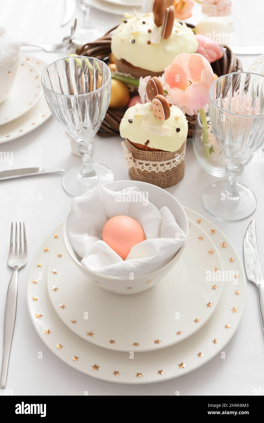 Beautiful table setting with pink Easter egg in room, closeup Stock Photo