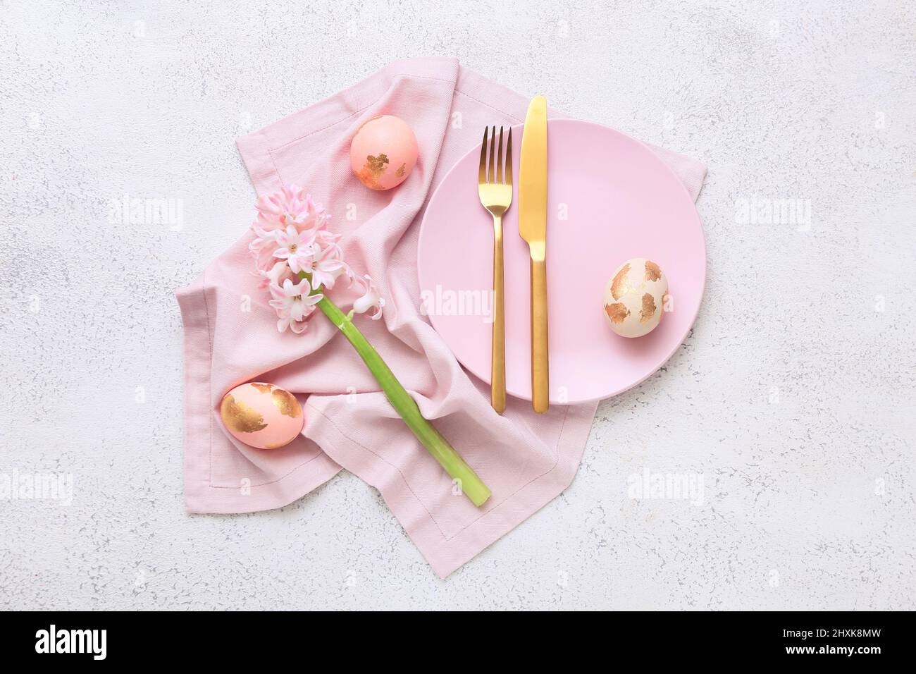 Beautiful table setting with Easter eggs and flowers on white ...