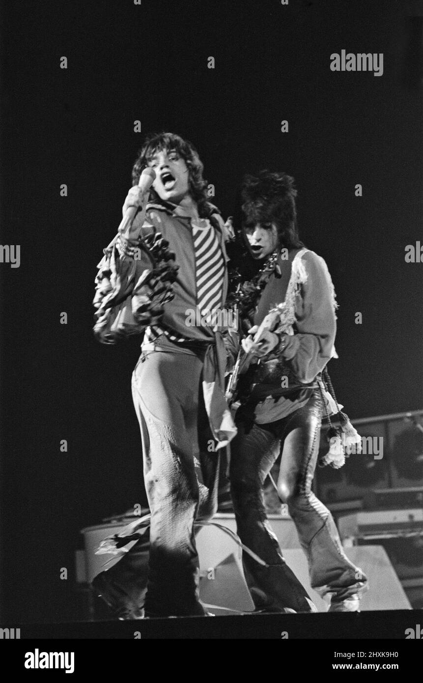 The Rolling Stones - live at Earl's Court, West London. Picture shows Mick Jagger and Ronnie Wood together onstage.  This concert was part of the 1976 European Tour. It started in Frankfurt Germany on 28th April and ended at Knebworth in England on 21st August 1976.  Whilst we cannot confirm the actual set list for this show, a typical set list for this tour was...  'Honky Tonk Women' 'If You Can't Rock Me'/'Get off of My Cloud' 'Hand of Fate' 'Hey Negrita' 'Ain't Too Proud to Beg' 'Fool to Cry' 'Hot Stuff' 'Star Star' 'Angie' - [played some shows] 'You Gotta Move' 'You Can't Always Get What Y Stock Photo