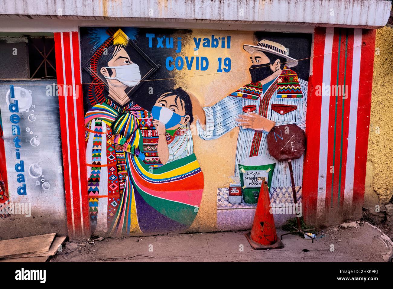 Covid mural encouraging mask wearing in traditional Todos Santos Cuchumatán, Huehuetenango, Guatemala Stock Photo