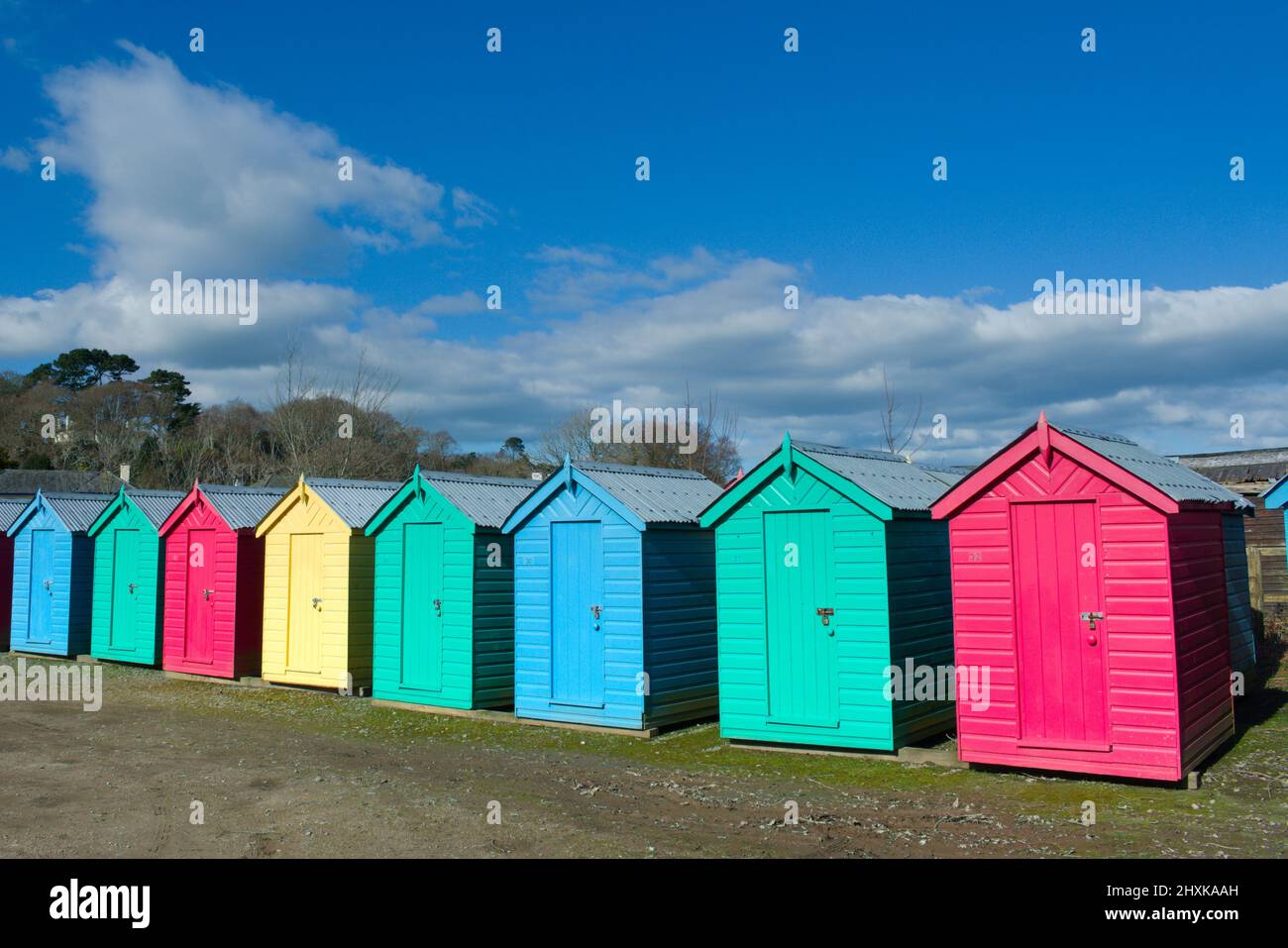 Iconic, traditional beach huts. Typical British seaside scene at Abersoch, north Wales on a sunny spring day. Stock Photo