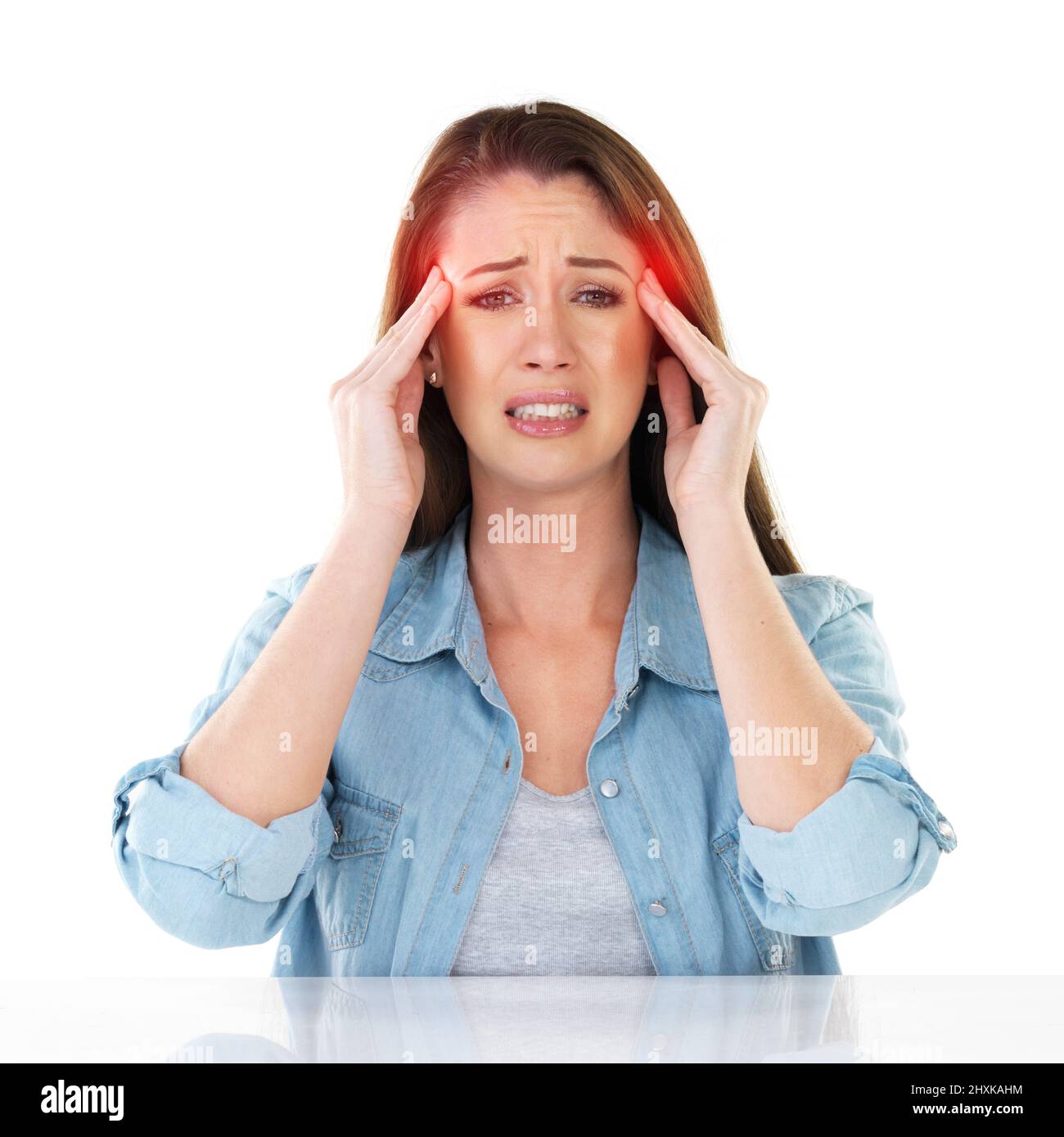 Make it go away. Studio shot of a young woman experiencing a headache