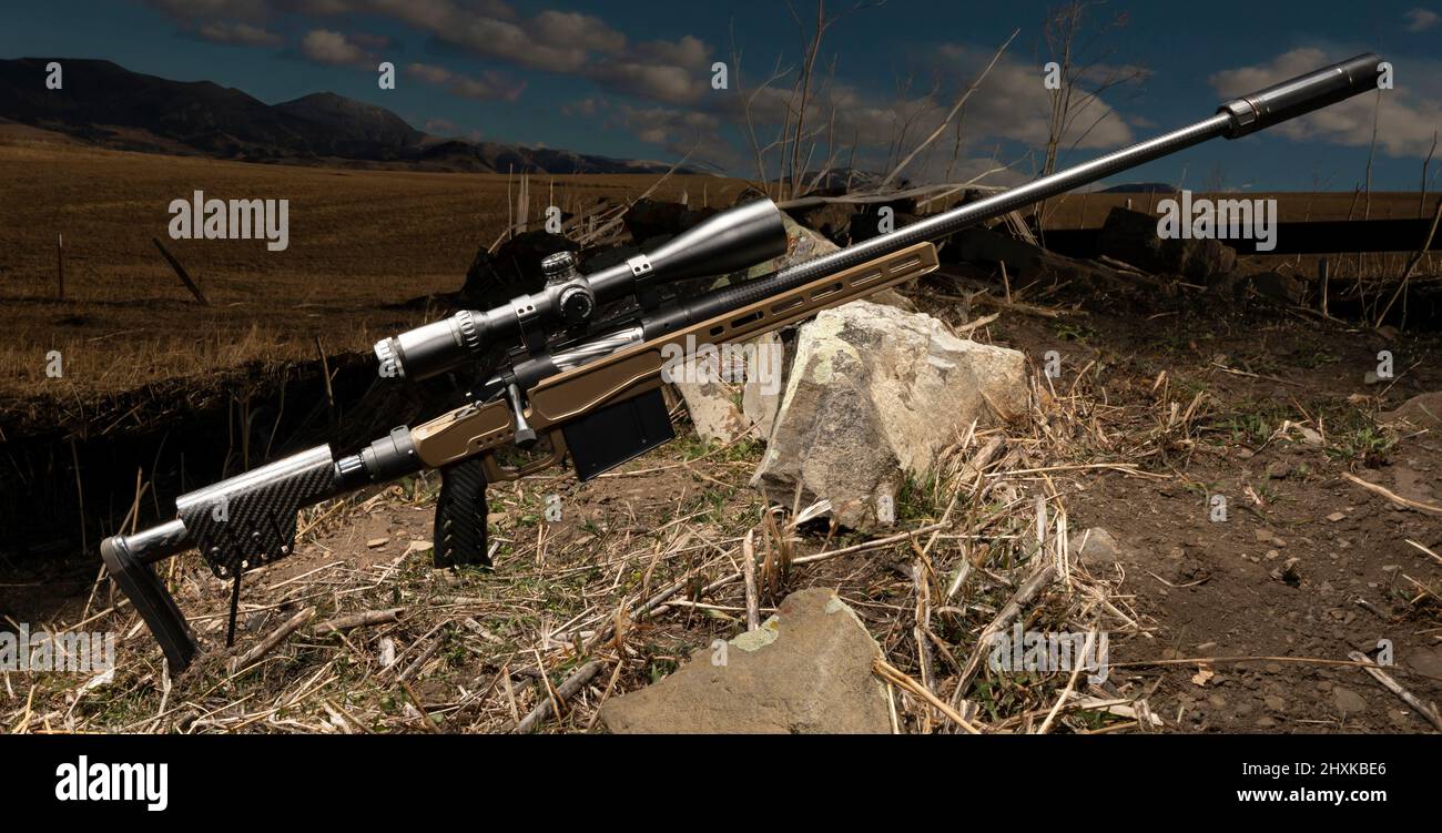 High powered rifle in a field with a suppressor and riflescope Stock ...