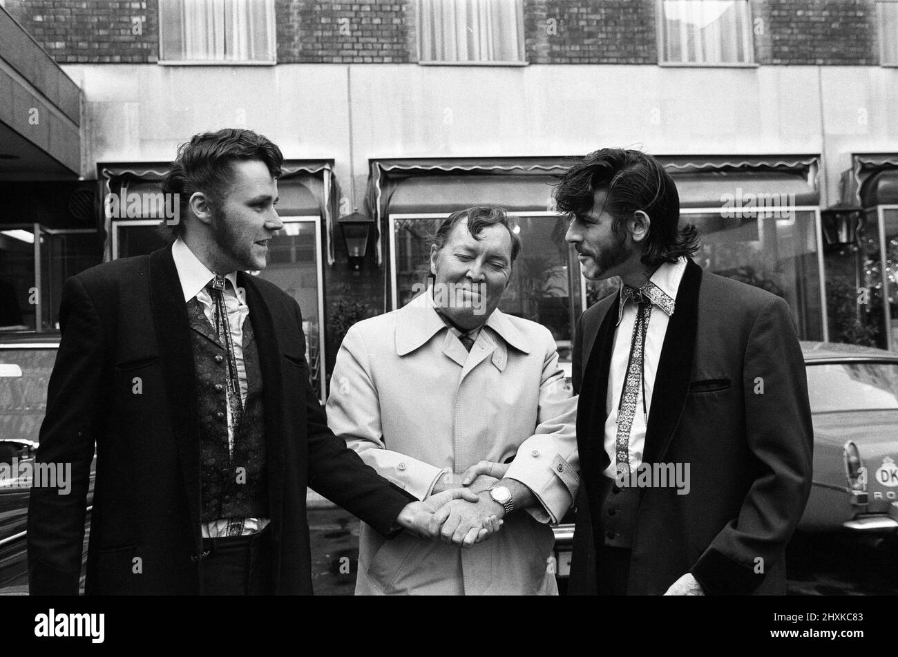 Two Teddy Boys suitably attired made an appointment with Bill Haley, King of Rock 'n' Roll. They apologised to him on behalf of rock fans after Haley's concert on Friday last week was wrecked by 'Plastics', the younger fans. 6th December 1976. Stock Photo