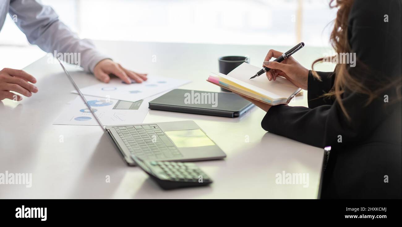 Asian business adviser meeting to analyze and discuss the situation on the financial report in the meeting room.Investment Consultant,Financial Stock Photo