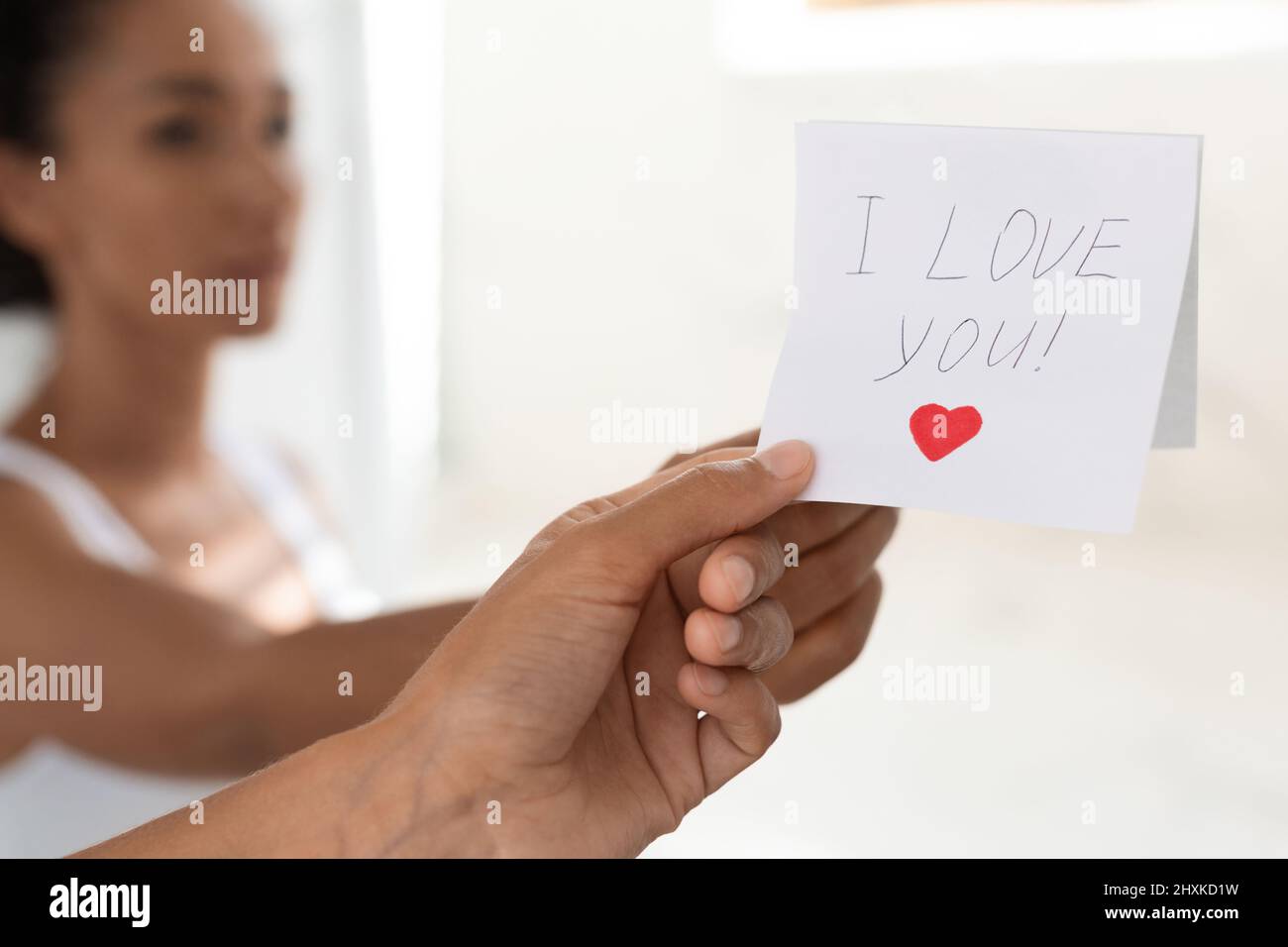 Woman Taking Off Sticky Note With I Love You Text On Mirror Stock Photo