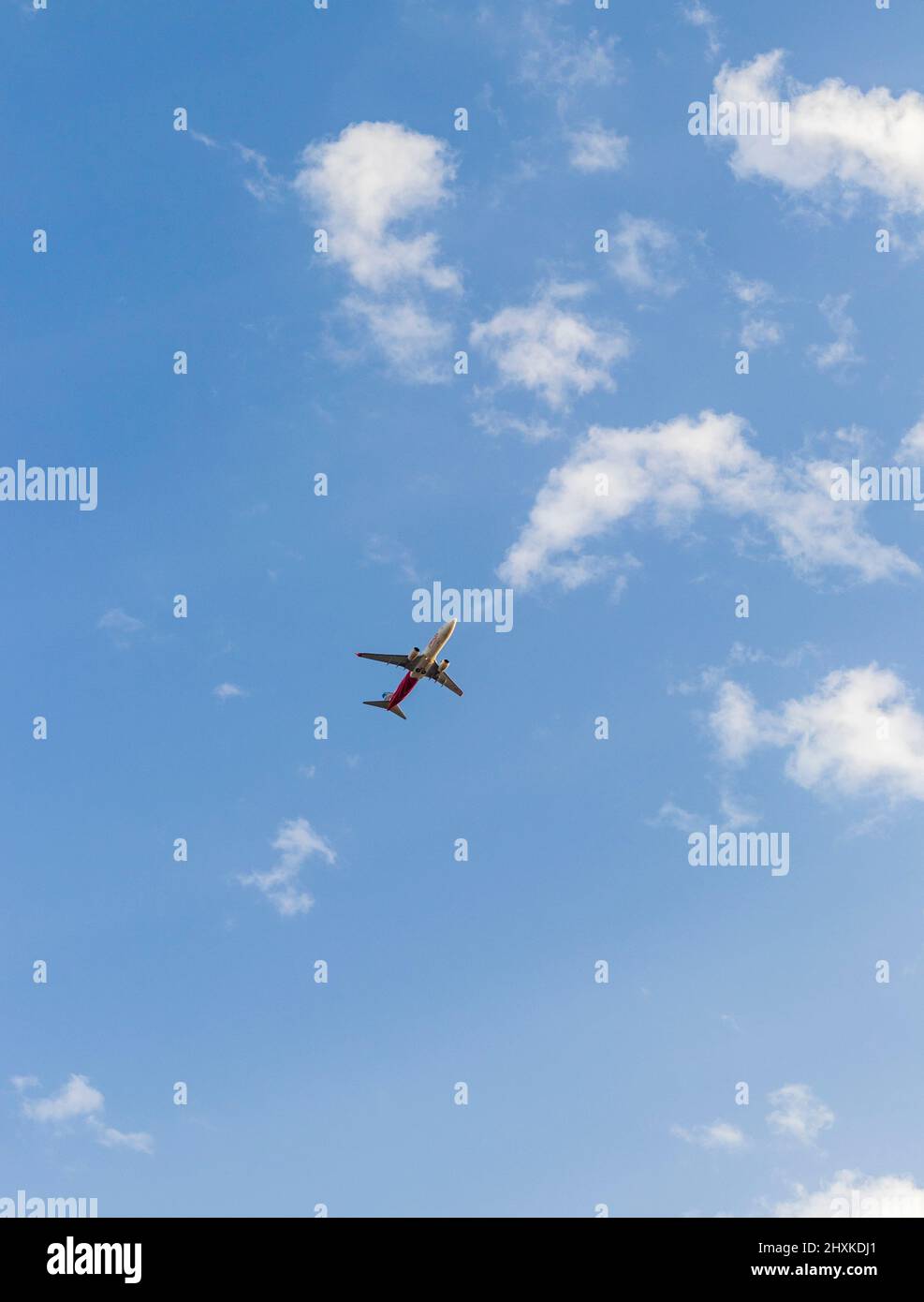 Shot of an airplane on blue sky background Stock Photo - Alamy