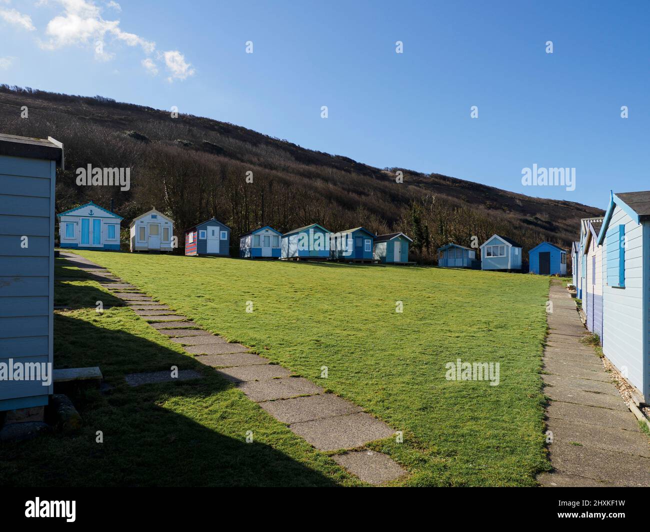 Beach huts around a triangle of grass below Kipling Tors, Westward Ho