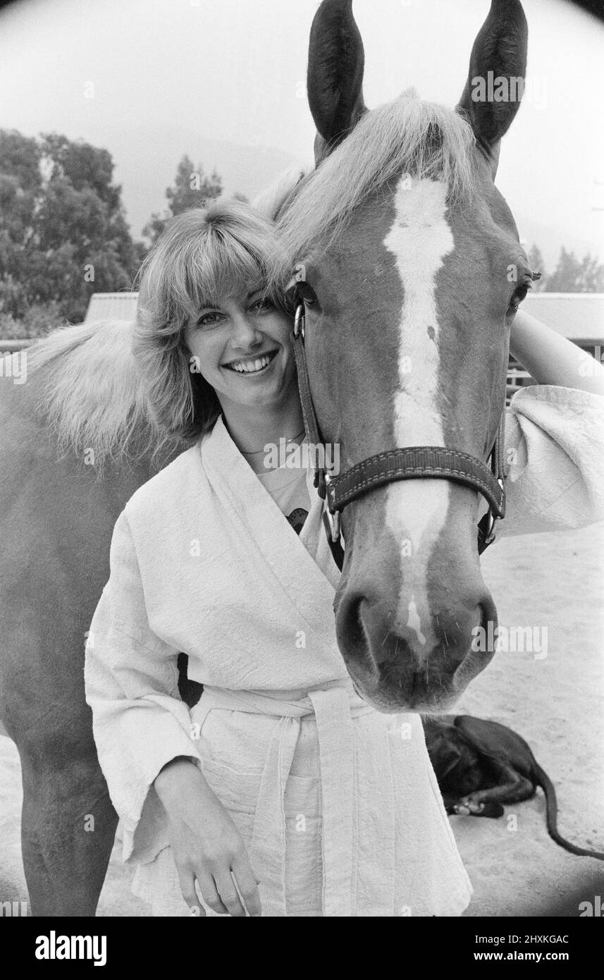 Olivia Newton John, singer and actor, pictured at home in Malibu, California, America.Pictured here with her horse.   Picture taken 25th July 1976 Stock Photo