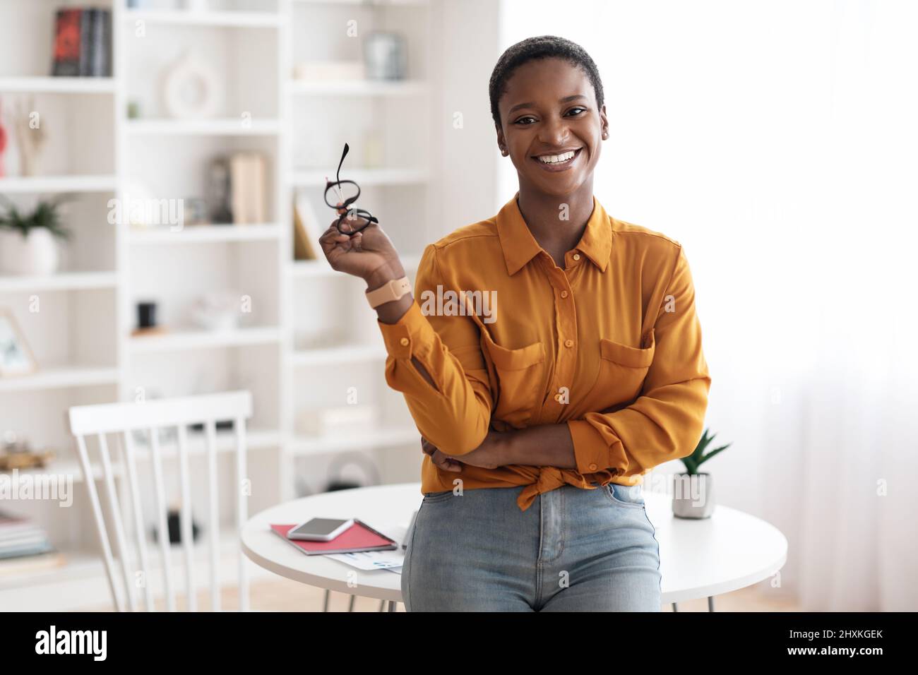 Happy young black woman posing at home Stock Photo - Alamy