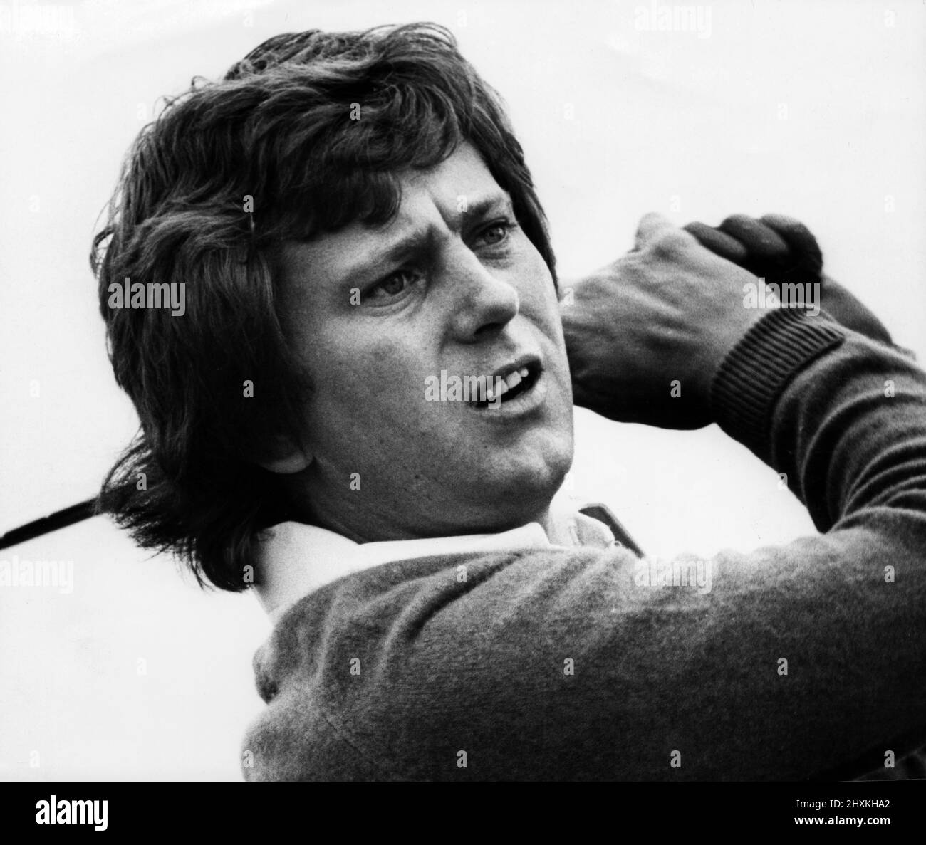 Doug McClelland, studies the line of his putt during the 72 holes Callers 25,000 pound golf tournament at Whitley Bay, this week, pictured 28th July 1977. Stock Photo