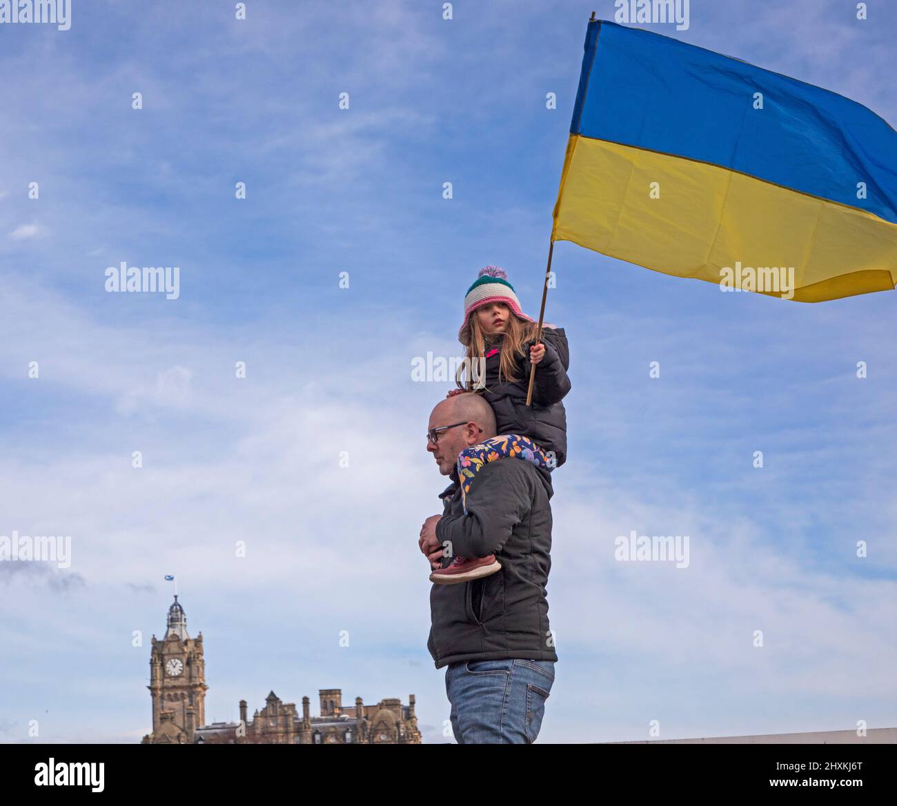 The Mound, Edinburgh, Scotland, UK. 13th March 2022. Protest and solidarity for Ukraine against the invasion from Russian miltary which began on 24th February 2022. Pictured: Erica holds the Ukrainian flag aloft. Credit Archwhite/alamy live news Stock Photo