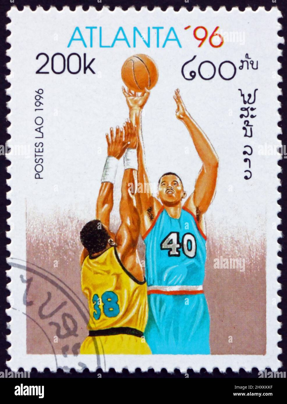 LAOS - CIRCA 1996: a stamp printed in Laos shows basketball, 1996 Summer Olympics, Atlanta, circa 1996 Stock Photo