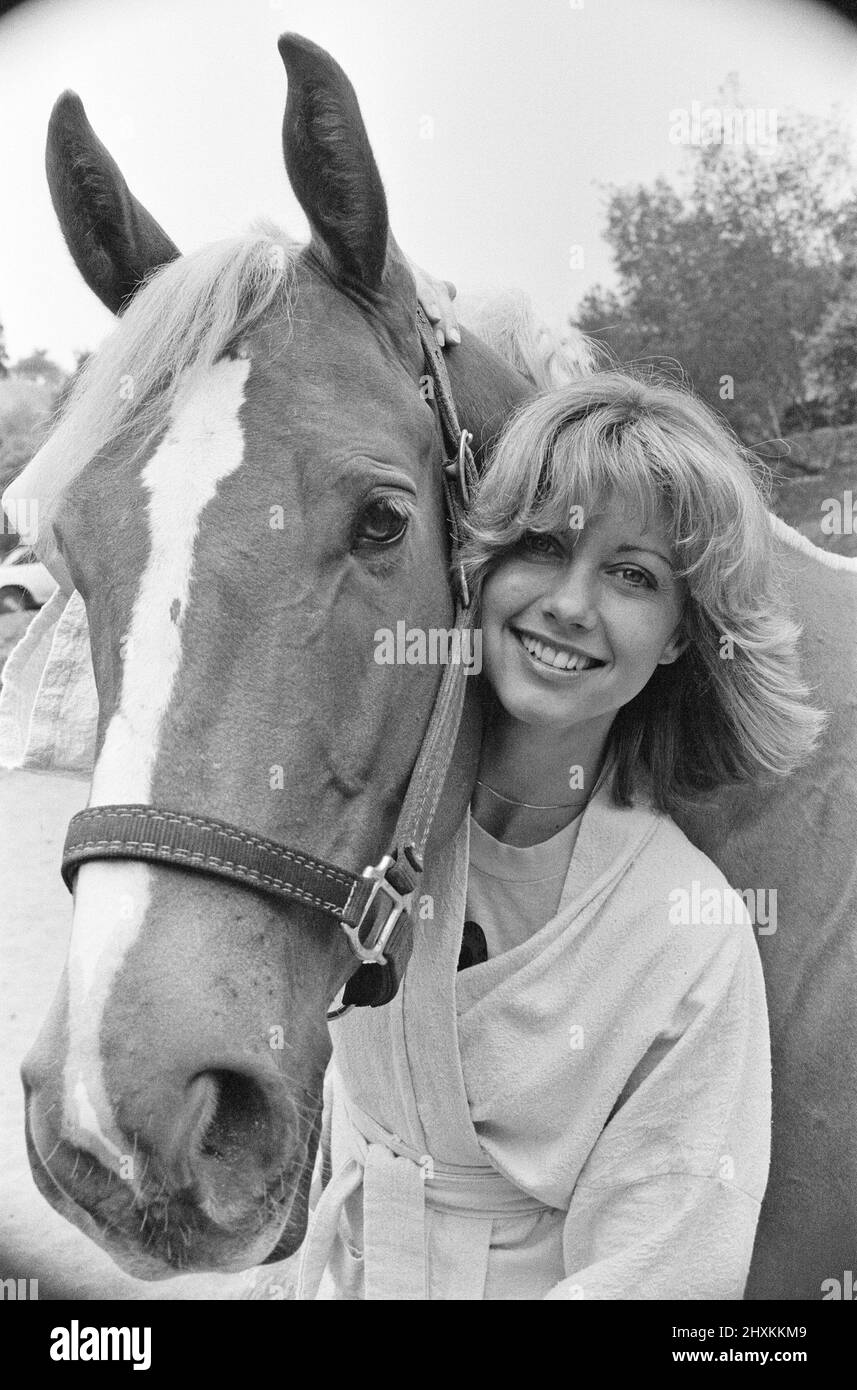 Olivia Newton John, singer and actor, pictured at home in Malibu, California, America.Pictured here with her horse.   Picture taken 25th July 1976 Stock Photo