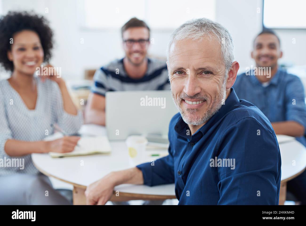 Taking his team to new places. Portrait of a group of designers at work in an office. Stock Photo